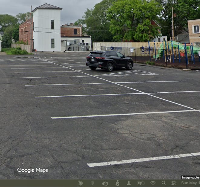 The large parking lot behind Gatherings at Station 10, shared with the neighboring church